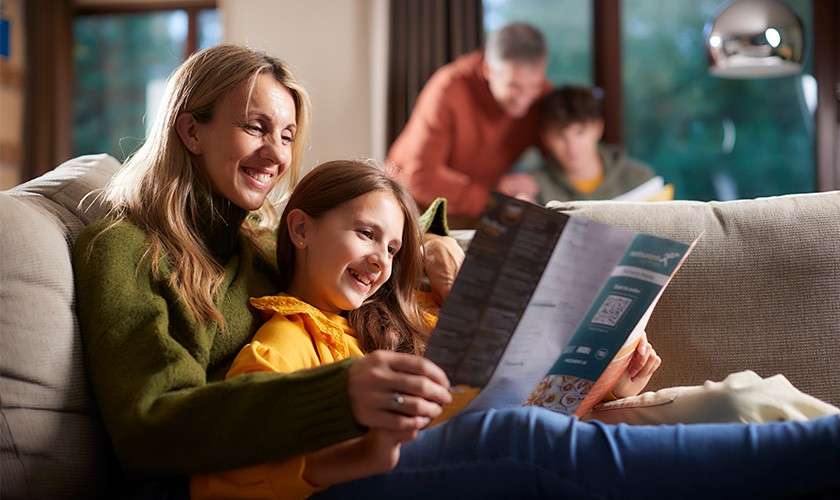 Mother and daughter reading a brochure