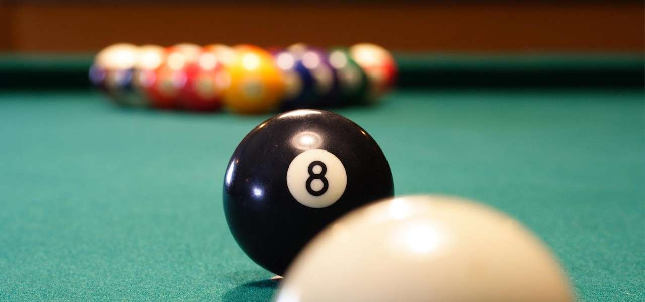 Close up image of the balls on a pool table.