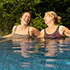 Two women relaxing in an outdoor pool at Aqua Sana spa.